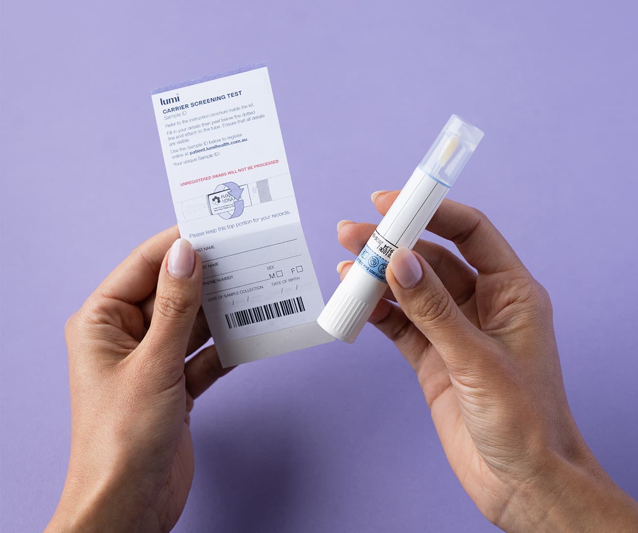 a close up of hands holding a Lumi Sample ID and swab