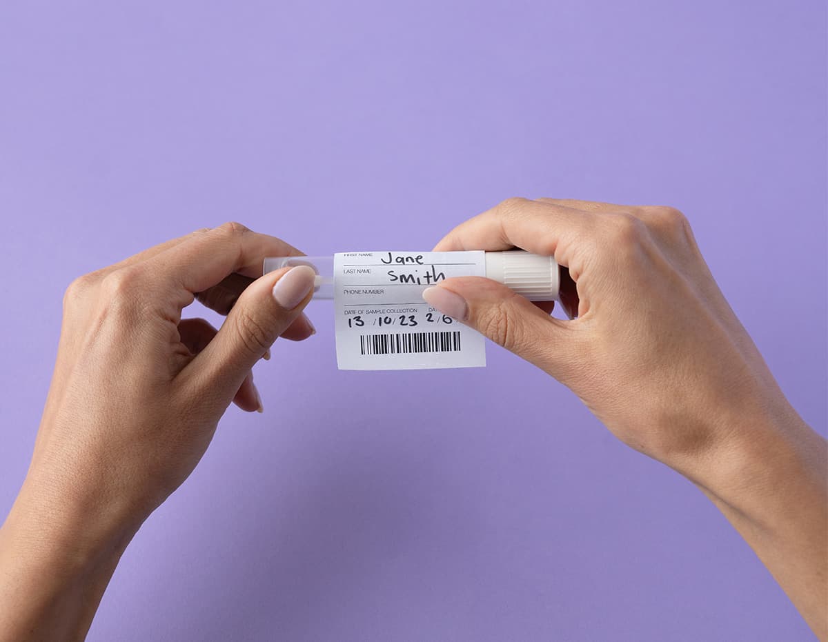 putting a Lumi Sample ID barcode on a swab