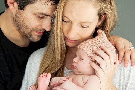 Rachel and Johnathan Casella holding their baby